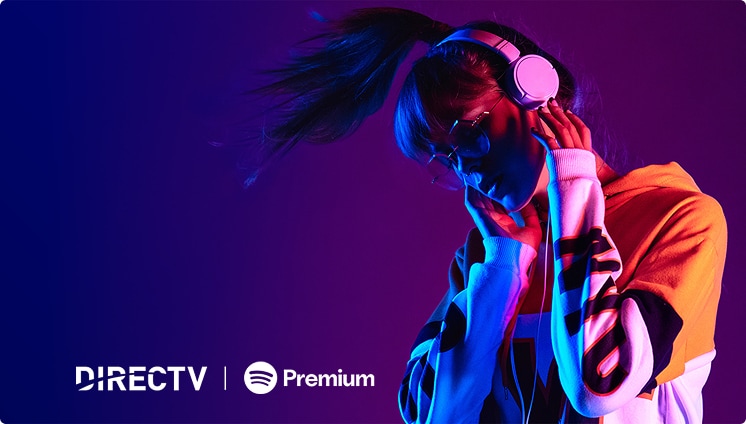 A rainbow colored scene shows a hand holding a shiny disco ball microphone in front of tropical plants with the Spotify premium logo in the corner