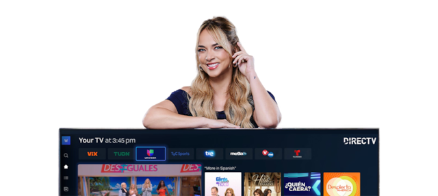 Person smiling next to a TV screen showing Spanish-language content interface.