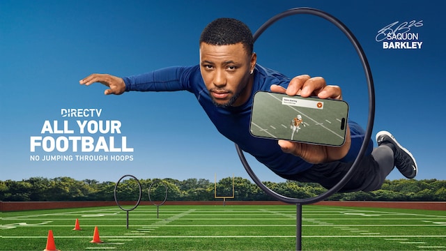 Saquon Barkley jumping through a training hoop on a football field while holding a phone with notifications from a Texas football game.