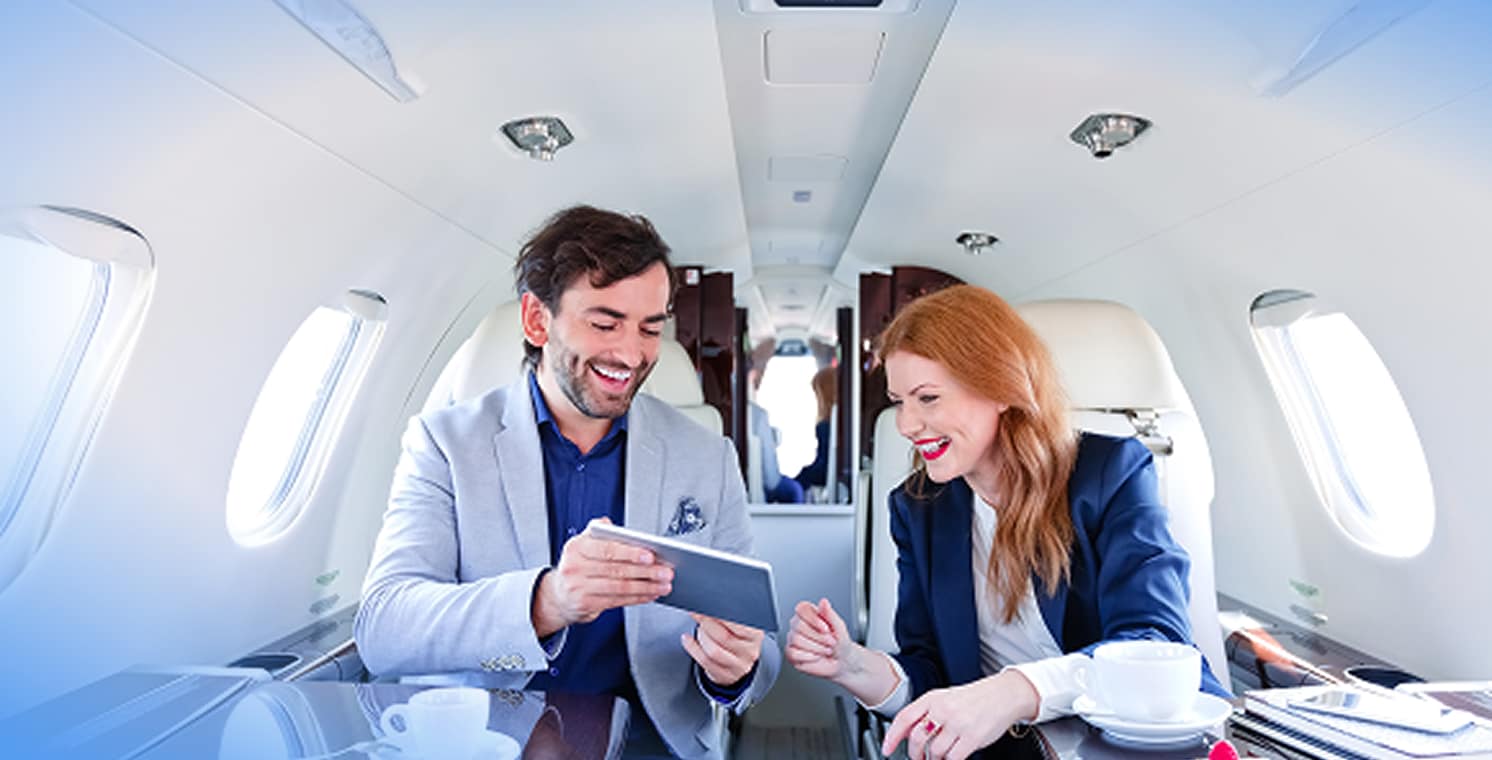 DIRECTV FOR BUSINESS. Man on a jet holding a remote control.