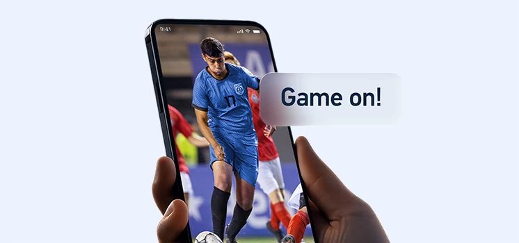 Mobile phone displaying a soccer game-time notification.