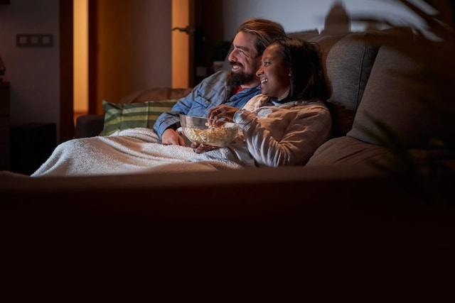 Couple watching a movie with DIRECTV.